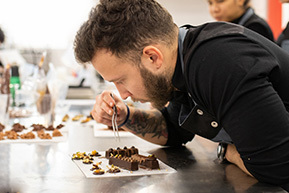 Professor cooking with chocolate sleeve from the Pastry and Chocolate course of the Culinary Institute of Barcelona