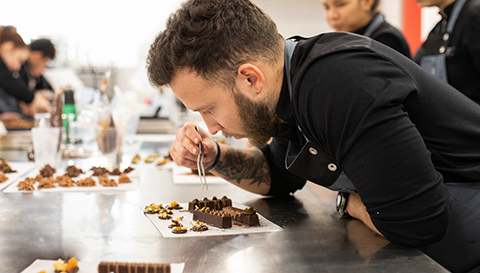 Student of the Postgraduate Course in Pastry and Chocolate at the Culinary Institute of Barcelona detailing a confectionery production.