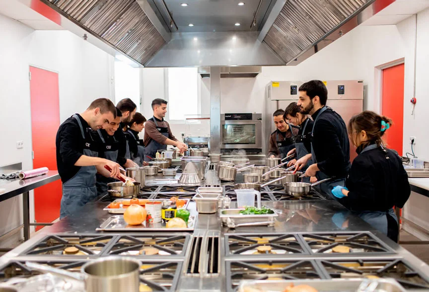 Haute cuisine students learning culinary techniques at CIB