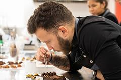 Student for professional pastry chef CIB Pastry chef making chocolates in the kitchen of the Culinary Institute of Barcelona.